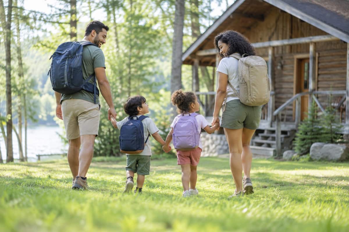 Parents walking hand in hand with their two young children